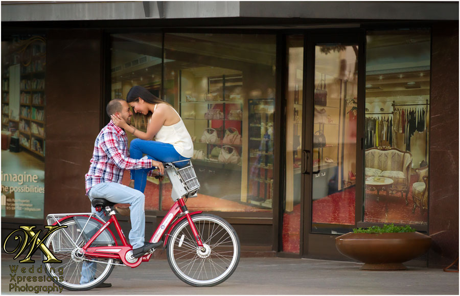 engaged couple on a bike