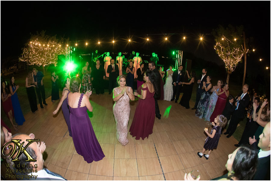 wedding guests dancing to live music at El Paso outdoor wedding reception captured by wedding photographers Wedding Xpressions