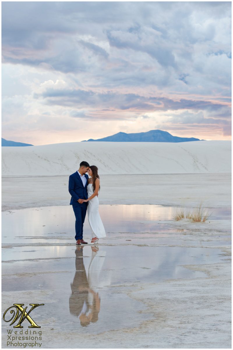 Alan and Illiana reflection in water at White Sands National Park engagement.