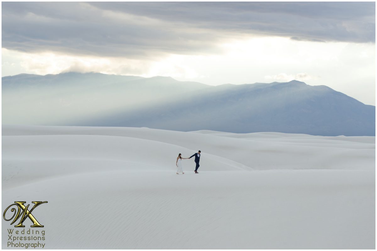 Ethereal white-on-white portrait of couple in the desert dunes.