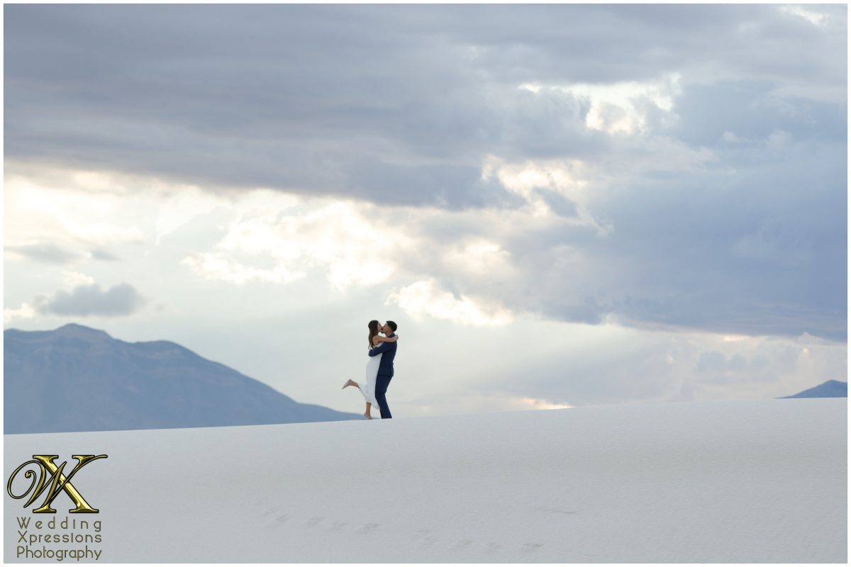 Dramatic sky over White Sands National Park engagement session.