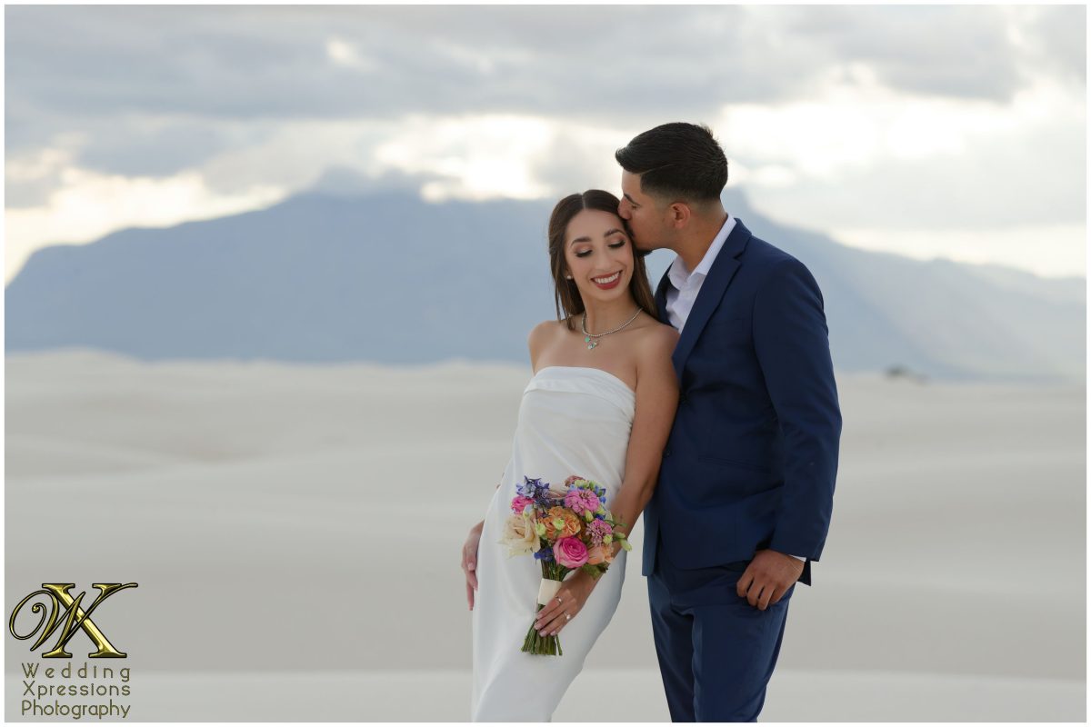 Sweet forehead kiss during White Sands engagement session.