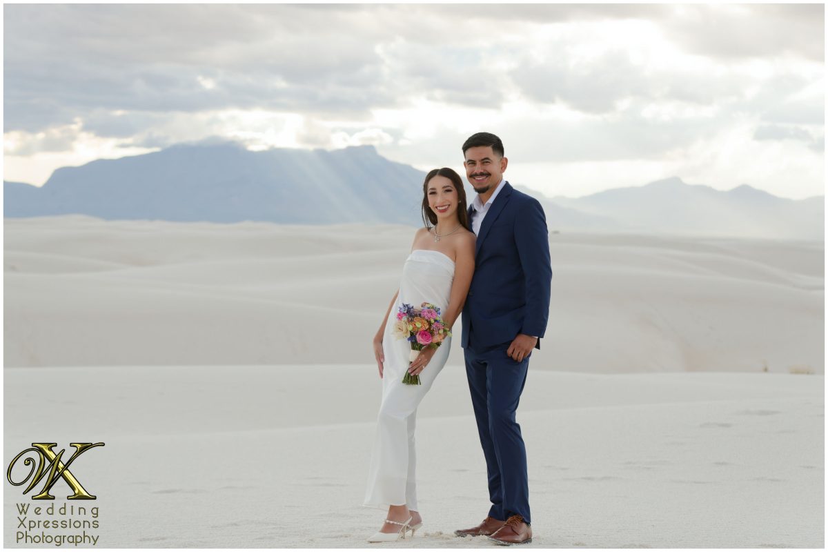 Couple laughing together in the middle of the dunes.