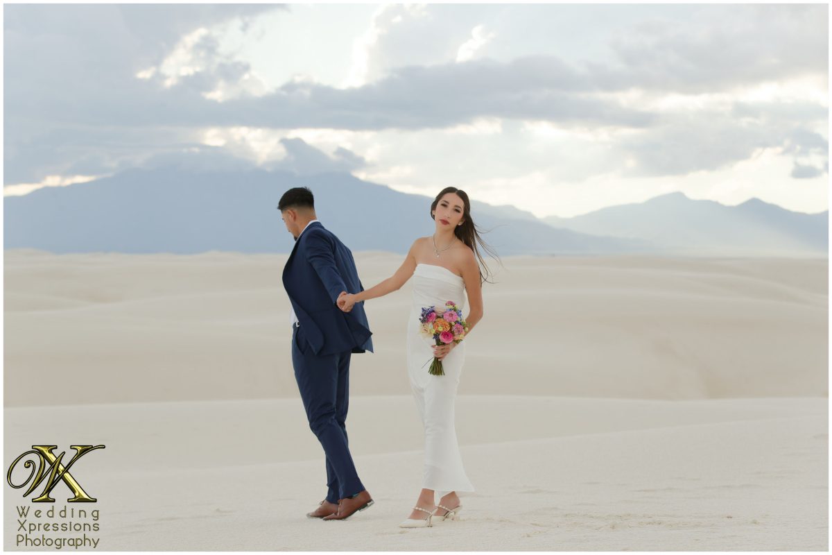 Romantic dip kiss on the white sand dunes.