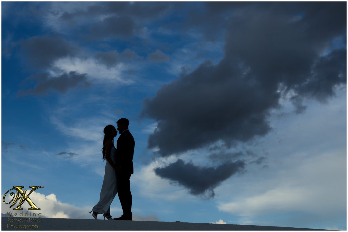 Silhouette of the couple at White Sands at twilight.
