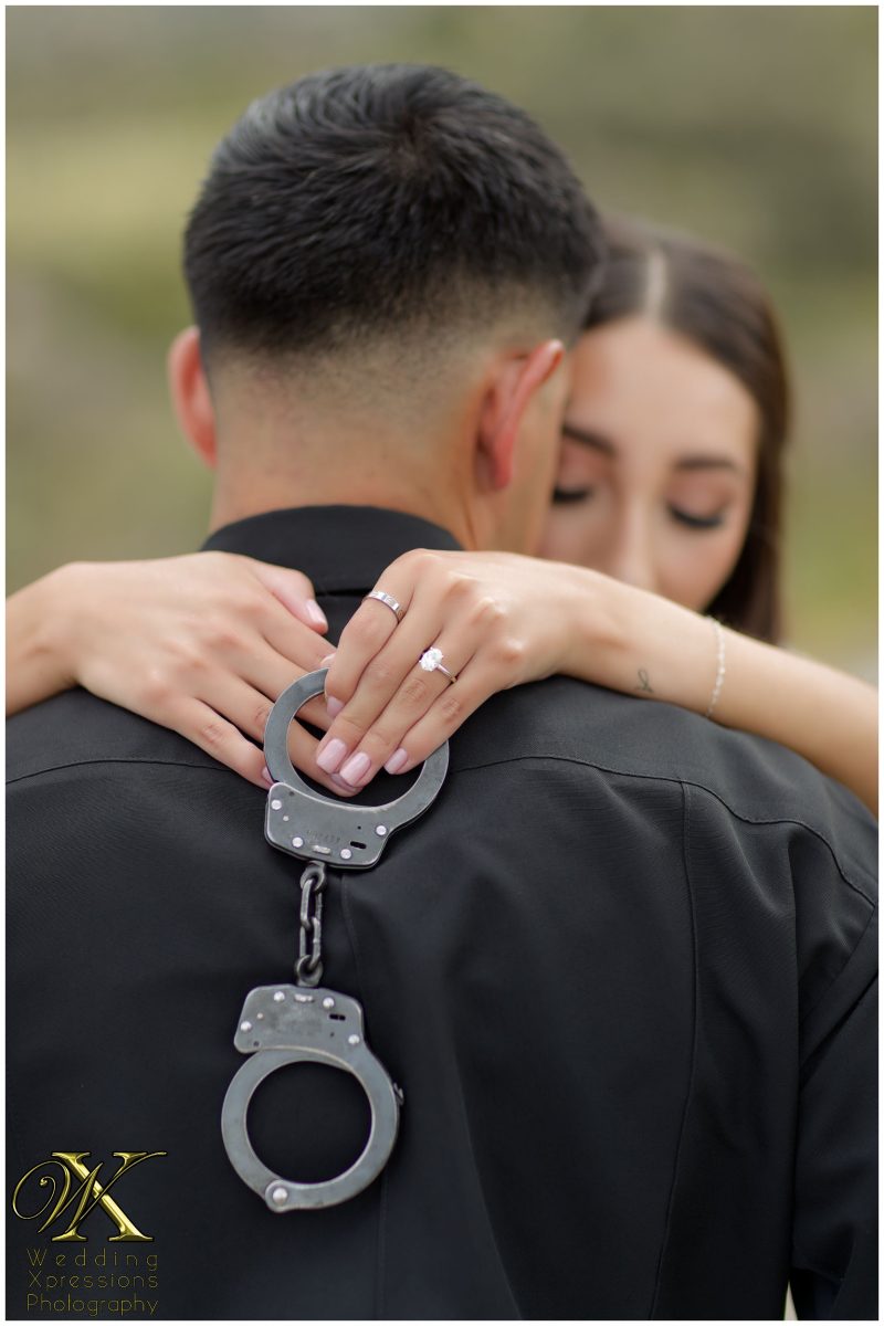 Illiana's hands on Alan's shoulders with personal details.