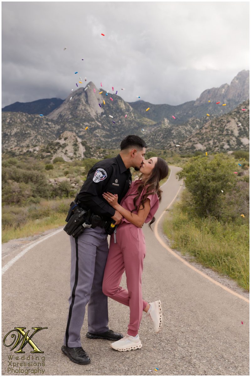 Couple kissing in their professional uniforms at Aguirre Springs.