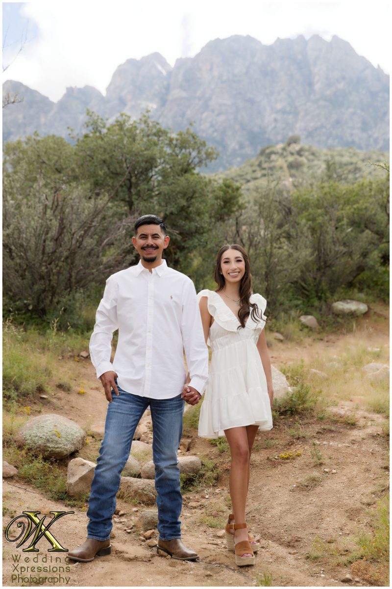 Couple standing in the desert brush at Aguirre Springs.