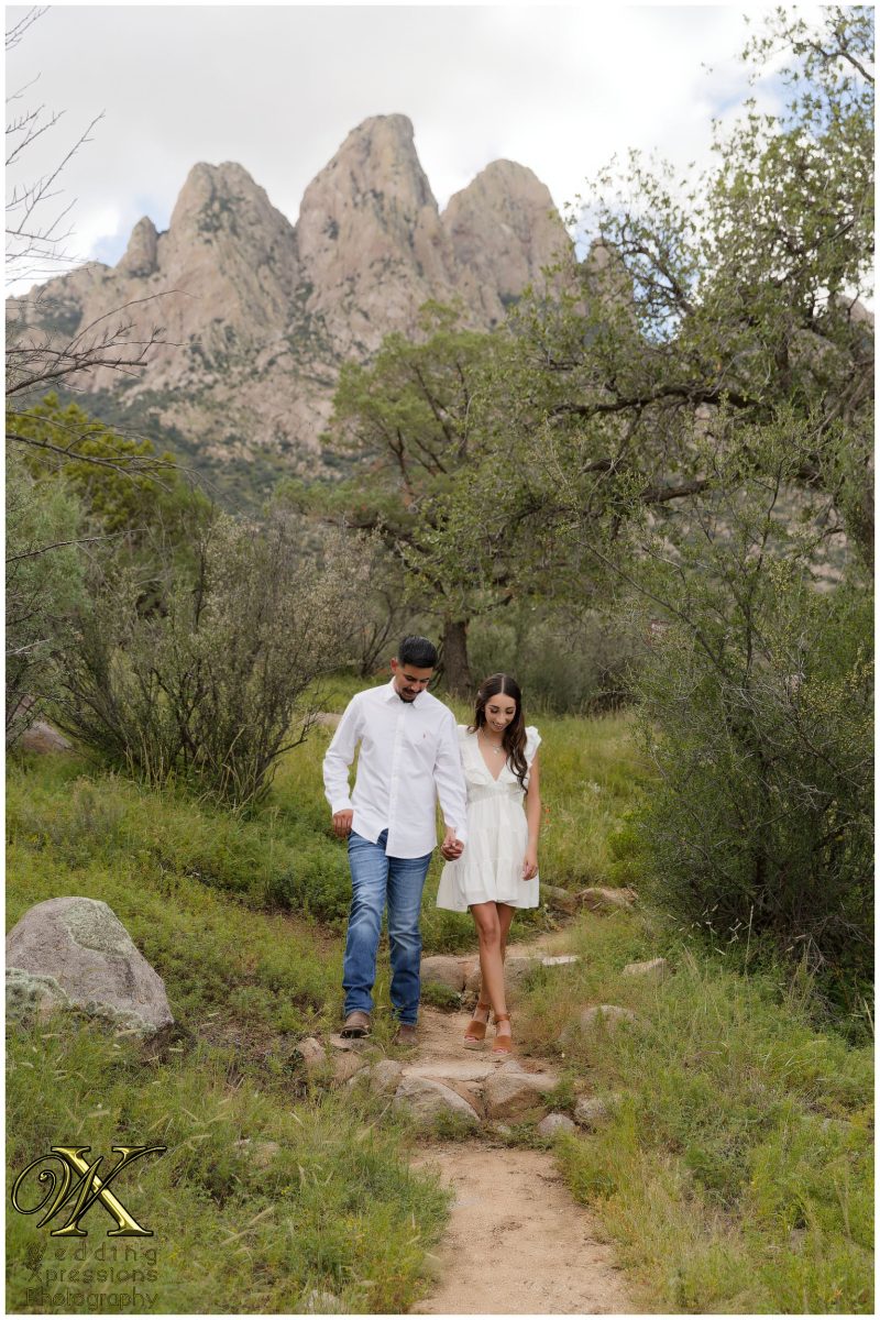 Couple standing on a mountain path at Aguirre Springs.