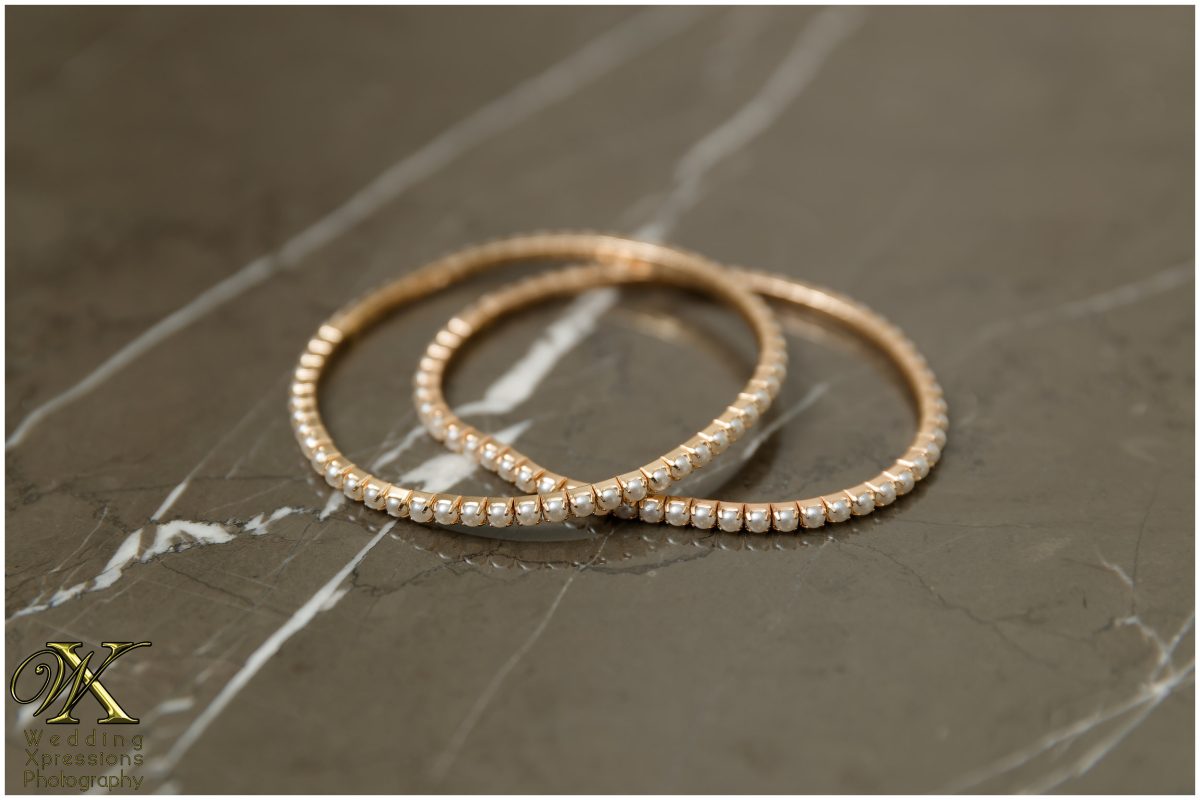 Close-up of bridal jewelry showcasing the artistic curation of wedding details.