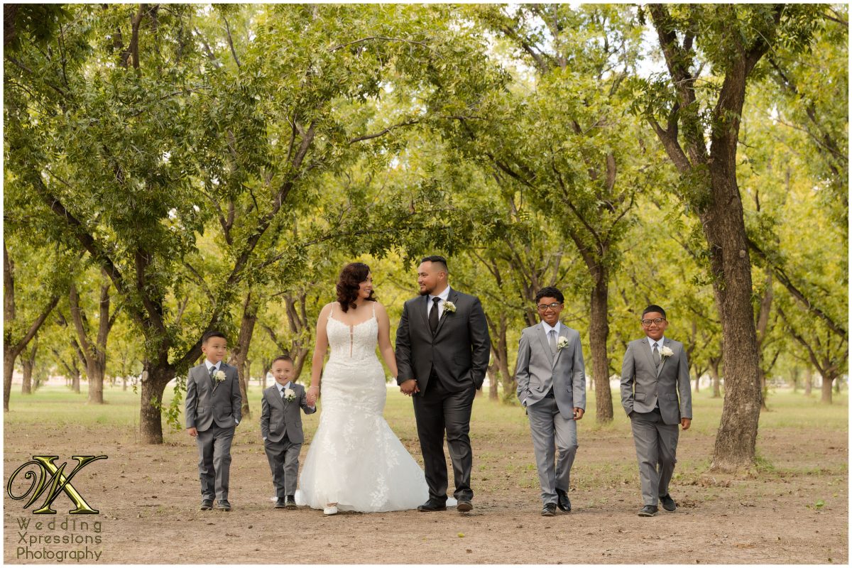 Christian and Melissa with their four sons, a grand family portrait in an El Paso pecan orchard.