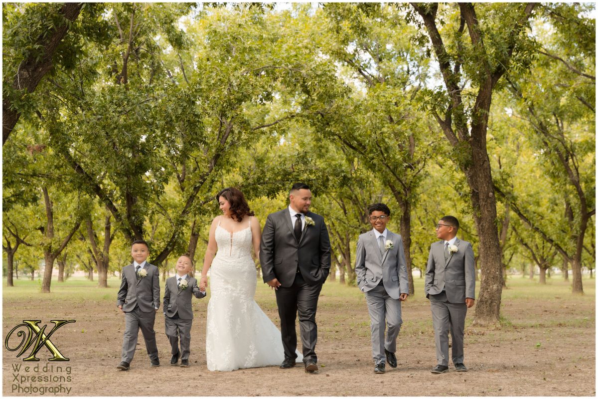 Christian and Melissa walking hand-in-hand with their sons, capturing their family legacy.