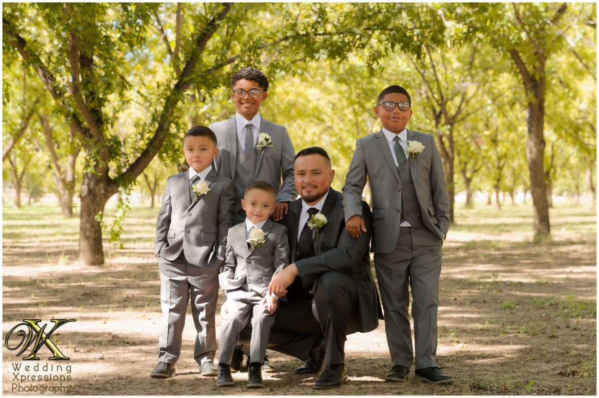 Heartfelt family portrait with the sons seated, documented by Wedding Xpressions Photography.