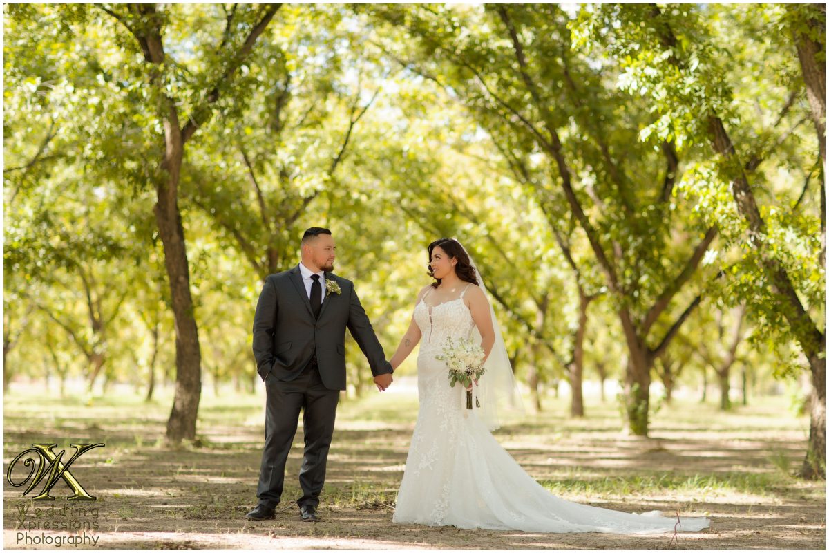 The couple sharing a romantic stroll through the natural beauty of El Paso’s orchards.