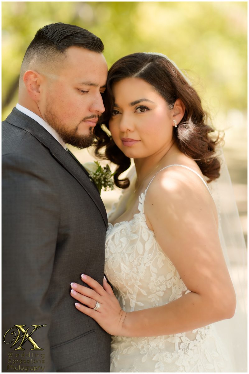 Close-up romantic portrait of Christian and Melissa in the soft orchard light.