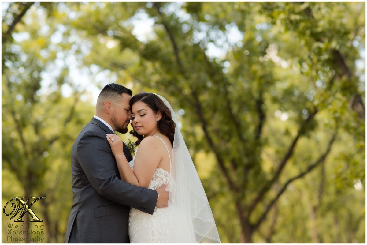 Joyful and candid laughter between the couple during their El Paso orchard session.