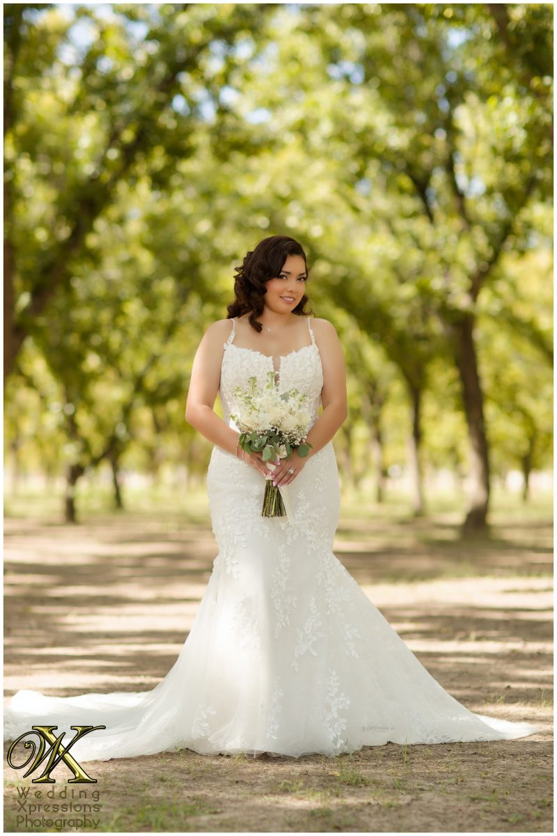 Melissa holding her luxury bouquet in the heart of the El Paso orchard.