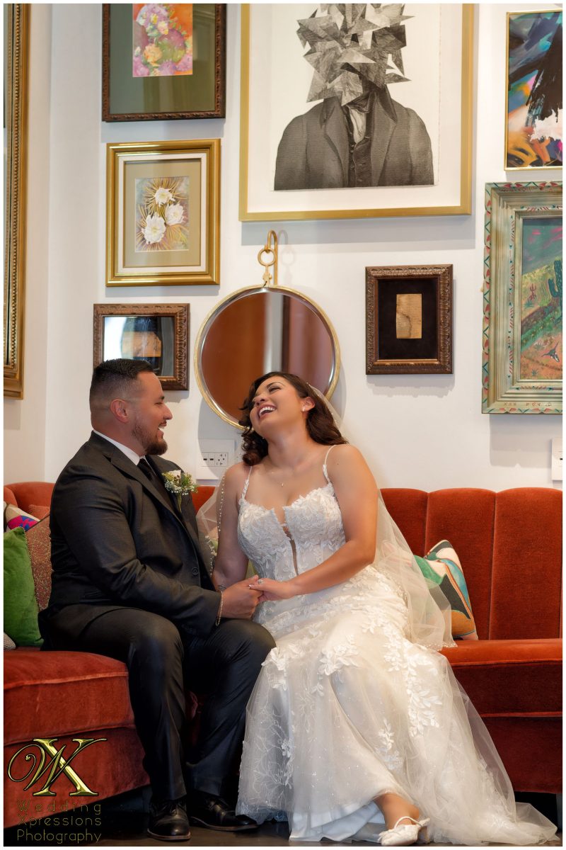 The wedding couple sharing a relaxed moment in the luxury interiors during wedding day at The Plaza Hotel Pioneer Park.
