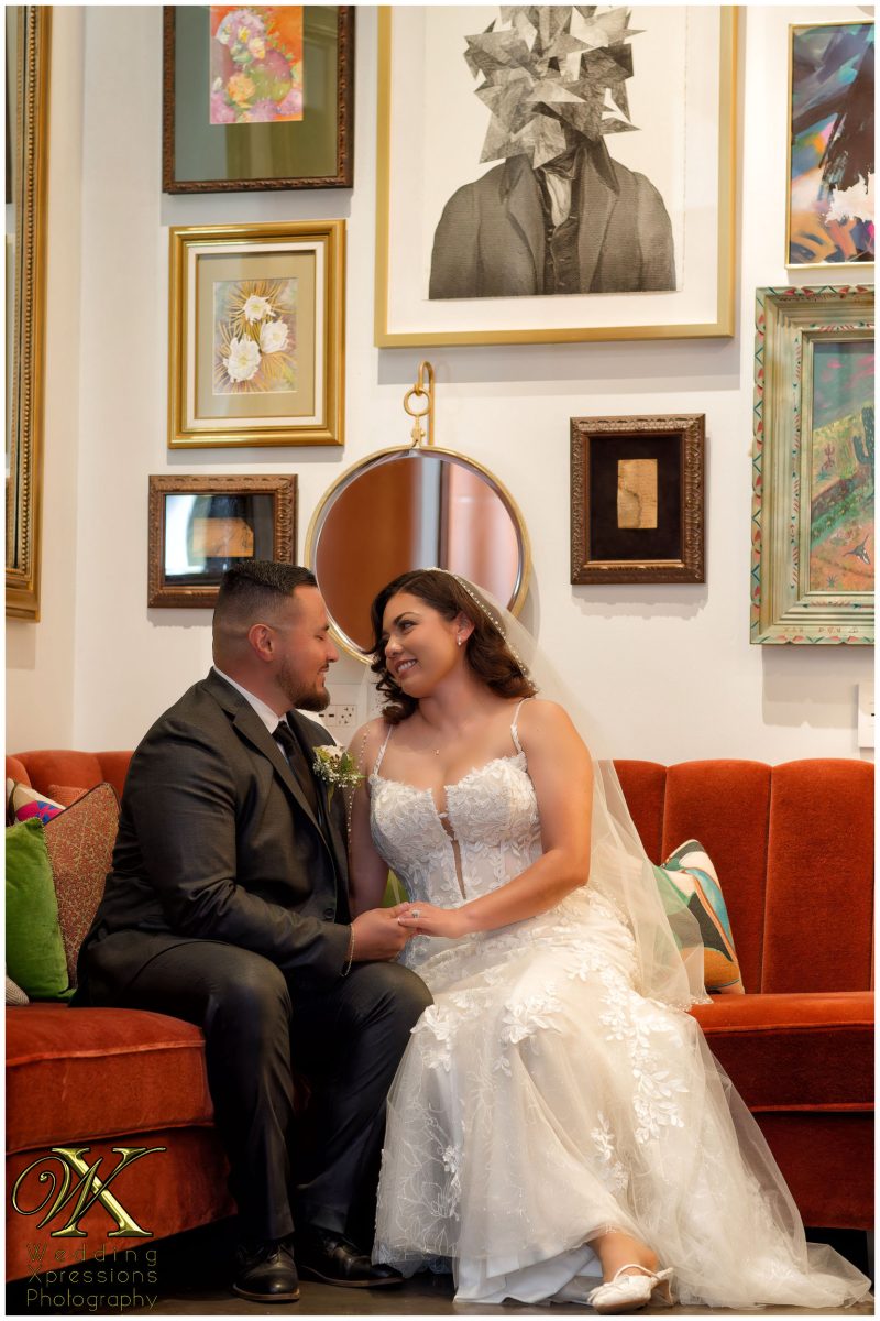 Sophisticated editorial portrait of the couple against the hotel's architectural beauty.