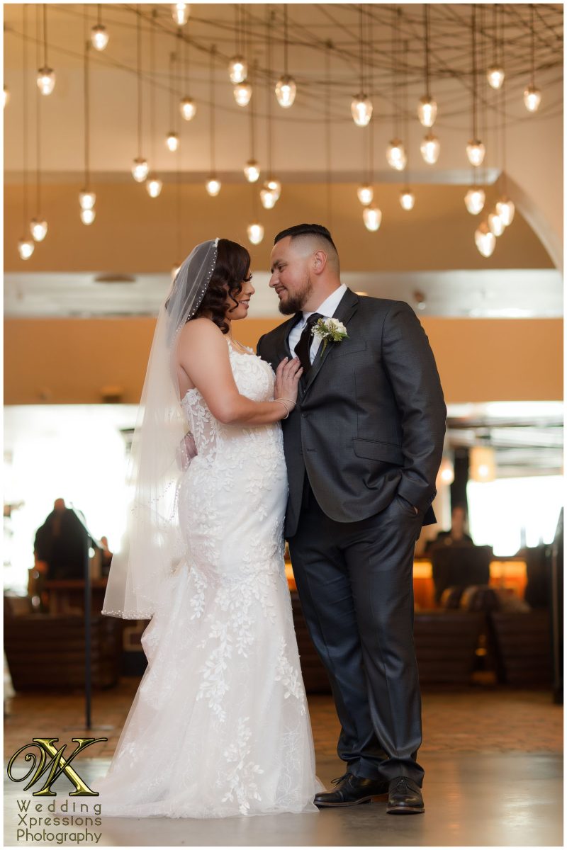 Christian and Melissa standing by the grand entrance of The Plaza Hotel Pioneer Park.