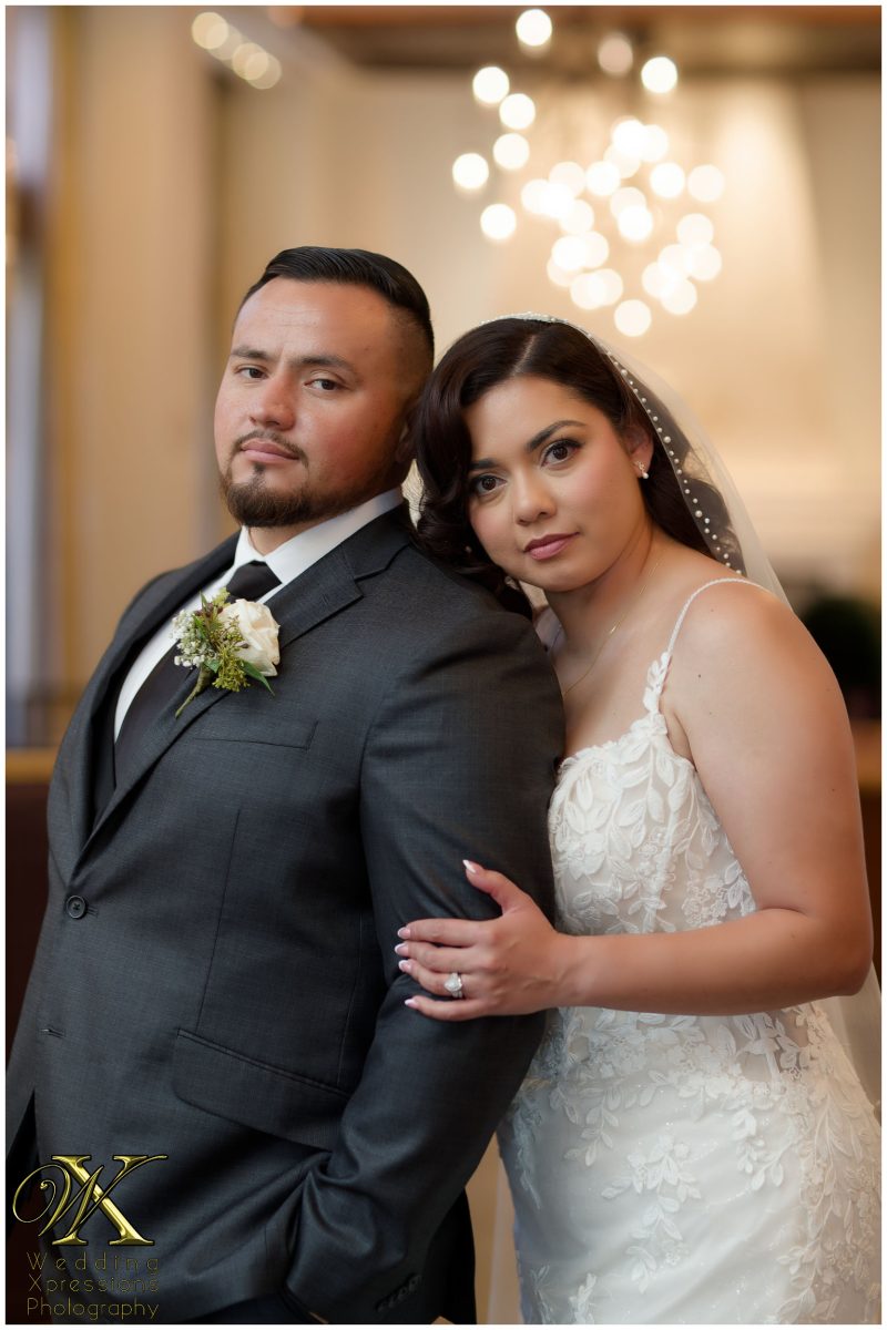 Close-up portrait of the couple at the hotel, showcasing their high-fashion wedding style.