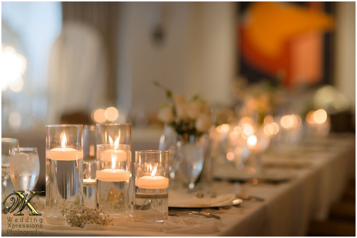 Close-up of candlelight and reception decor, creating a warm and romantic atmosphere.