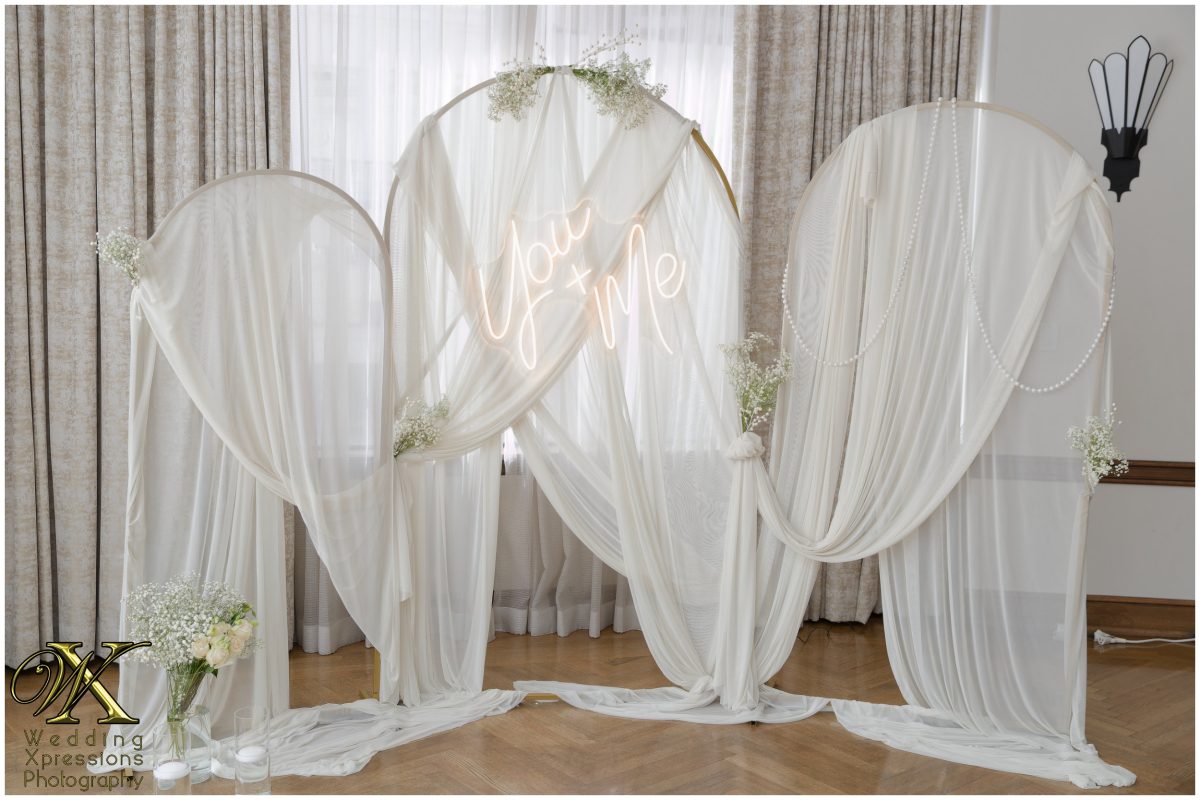 Elegant reception backdrop and florals at The Plaza Hotel Pioneer Park.