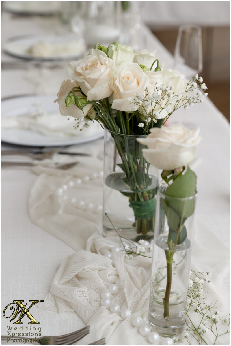 Detail of the elegant white floral centerpieces for the reception tables.
