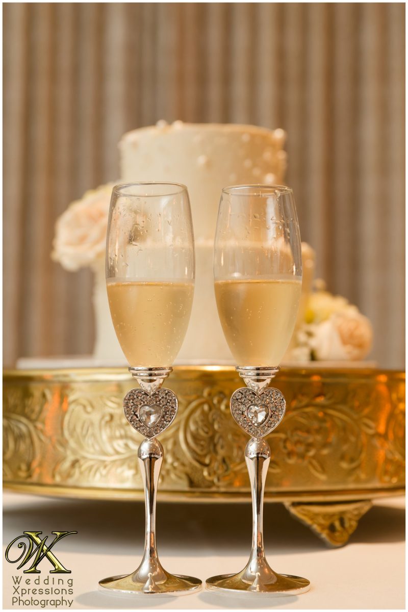 Champagne toast detail, celebrating the beginning of a new family legacy.