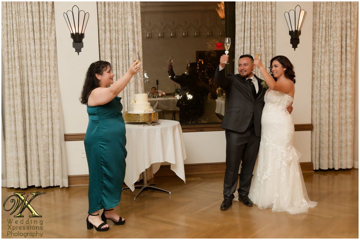 The couple raising a glass to their family and friends at The Plaza Hotel.