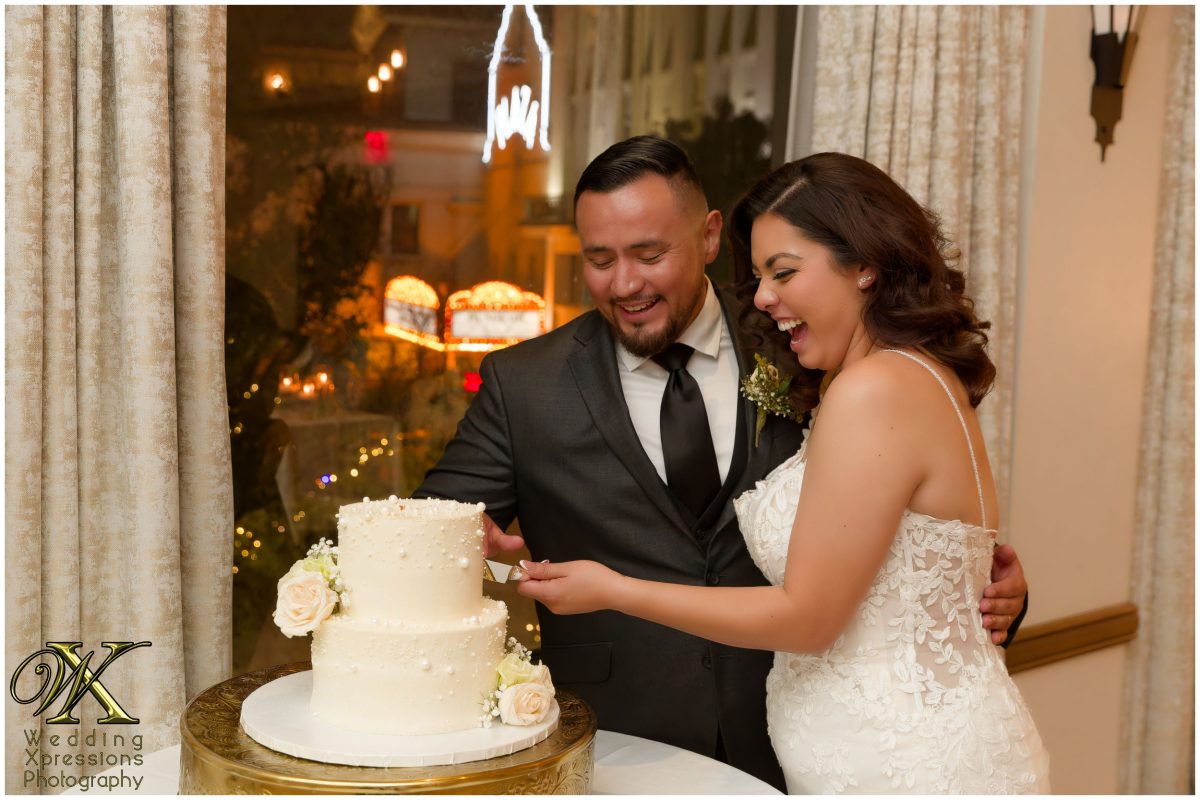 The couple sharing a sweet moment after cutting their cake.