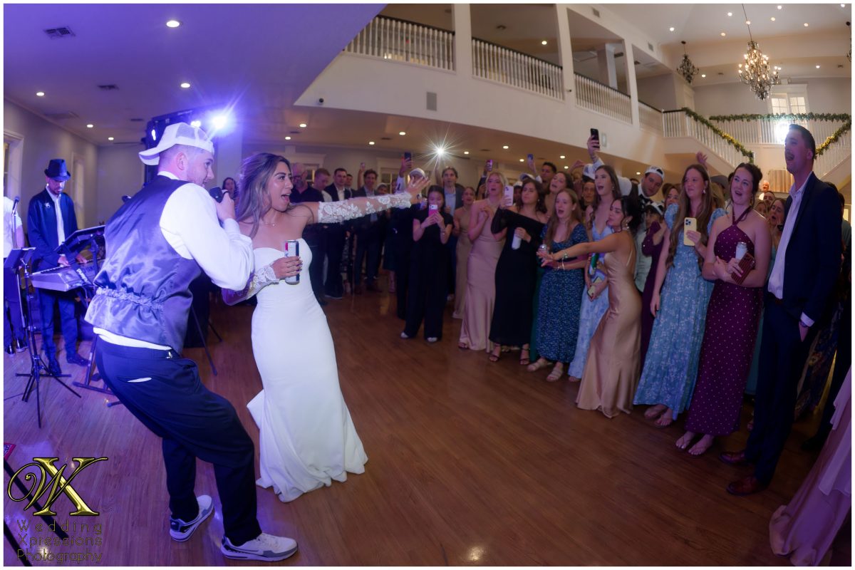 Bride and groom singing with Royal Dukes Band at Kendall Point reception.